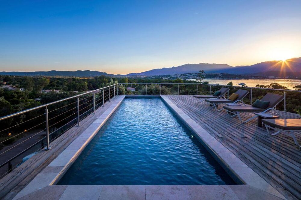 Piscine avec vue sur coucher de soleil.
