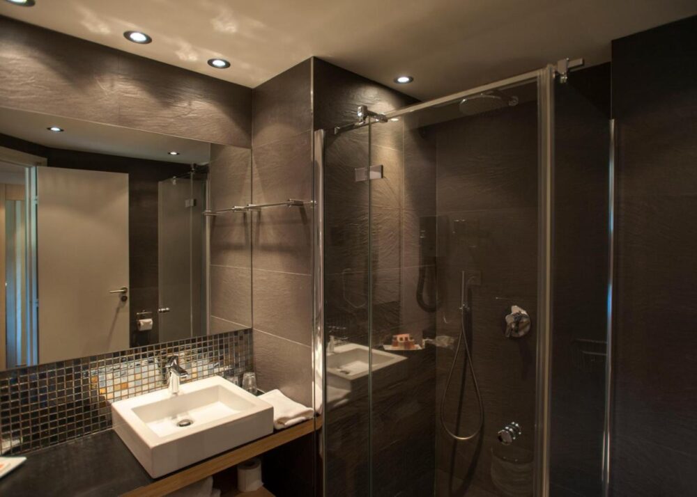 Salle de bain moderne avec douche et lavabo.