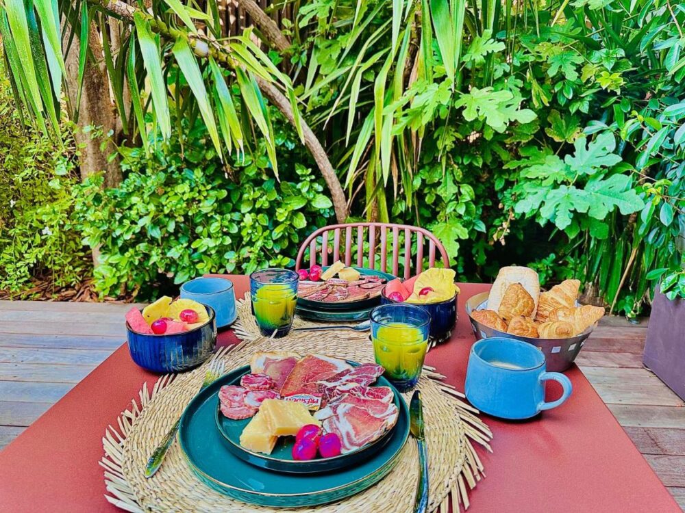 Petit-déjeuner en plein air avec fruits et viennoiseries.